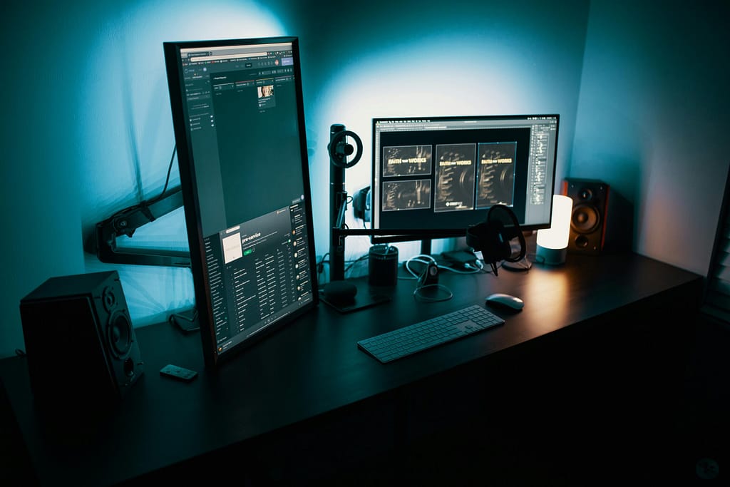 How Technology Is Changing the Way We Live and Work Today A contemporary office desk featuring a dual monitor setup with stylish lighting, ideal for tech enthusiasts.